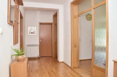 a hallway with a door and a clock on the wall at Apartman Buongiorno in Jajce