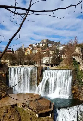 a view of a waterfall with buildings in the background at Apartman Buongiorno in Jajce