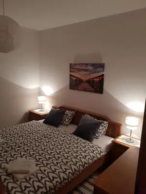 a bedroom with a bed and two lamps on tables at Apartman Buongiorno in Jajce