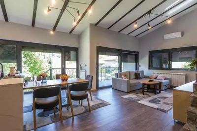 a kitchen and living room with a table and chairs at Modern House in Visoko in Visoko
