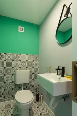a bathroom with a white toilet and a sink at Modern House in Visoko in Visoko