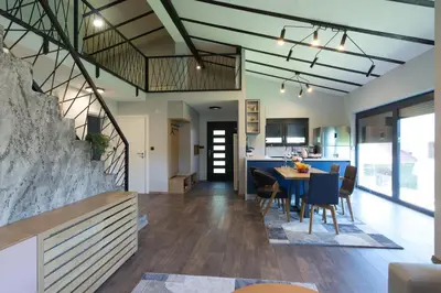 an open kitchen and dining room with a table and chairs at Modern House in Visoko in Visoko