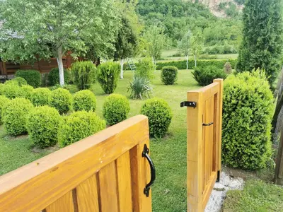 a wooden gate in a garden with bushes at Rest House Ripac in Praščijak