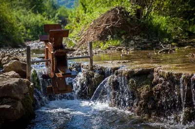 a water fall with a cross in the middle of a creek at Rest House Ripac in Praščijak