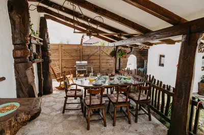 a dining room with a table and chairs at Holiday Home Bonum in Bihać