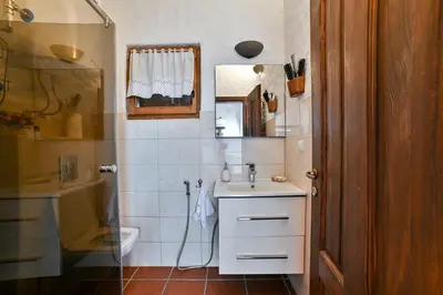 a bathroom with a sink and a toilet and a shower at Holiday Home Bonum in Bihać