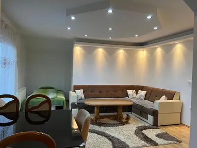 a living room with a couch and a table at Apartmani Piramida Mjeseca i Sunca in Visoko