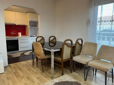 a kitchen with a dining room table and chairs at Apartmani Piramida Mjeseca i Sunca in Visoko