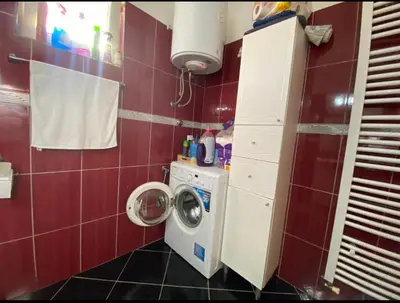 a small bathroom with a washing machine in it at Apartmani Piramida Mjeseca i Sunca in Visoko