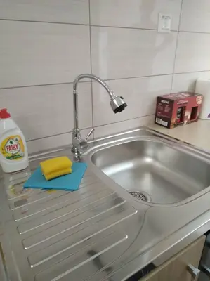 a kitchen sink with a sponge and a faucet at Studio by the river in Jajce