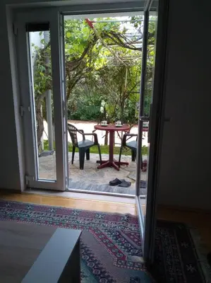 an open door to a patio with a table and chairs at Studio by the river in Jajce