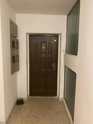 a brown door in a room with a hallway at A First class za 4 osobe 2 spavaće sobe in Tuzla