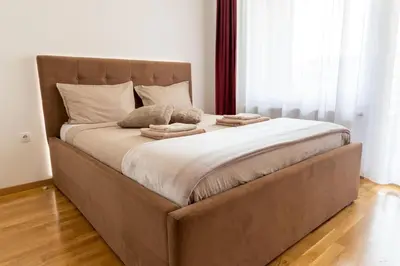a large bed with two pillows on top of it at Drobac apartman in Banja Luka