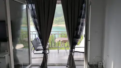 a room with a view of the ocean from a balcony at Amani in Kovačevo Polje