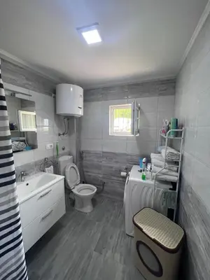 a bathroom with a toilet and a sink and a toilet istg at Amani in Kovačevo Polje
