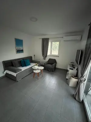 a living room with a couch and a table at Amani in Kovačevo Polje