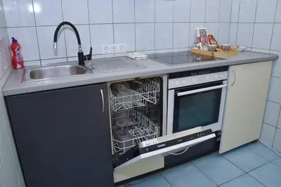 a dishwasher with its door open in a kitchen at Apartman Vinkov's center in Jajce