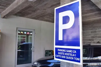 a parking sign in front of a parking garage at Apartman Vinkov's center in Jajce