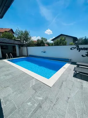 a swimming pool next to a white fence at Apartman Kiss in Jajce