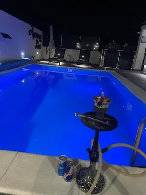 a swimming pool with a bar in front of it at Apartman Kiss in Jajce