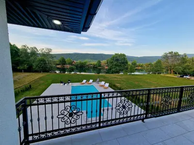 a balcony with a view of a swimming pool at Villa Eda in Bihać