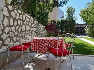 a table and chairs with a red and white tablecloth at Visoko New Concept - 7 minutes from the Pyramids - City Center in Visoko