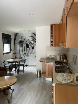 a kitchen with a table and a dining room at Visoko New Concept - 7 minutes from the Pyramids - City Center in Visoko