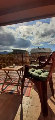 a wooden chair sitting on top of a balcony at IKA-M in Bihać