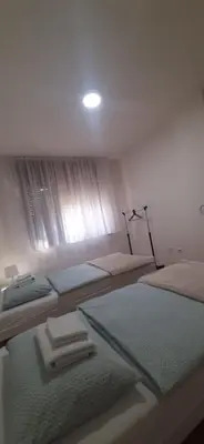 a bedroom with two twin beds and a window at IKA-M in Bihać