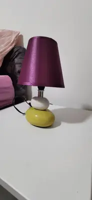 a yellow lamp with a purple lamp shade on a table at Teslić Apartman NiA in Teslić