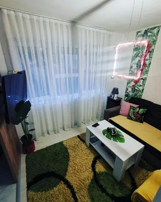 a living room with a couch and a table at Teslić Apartman NiA in Teslić