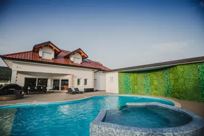a swimming pool in the backyard of a house at Grand villa Bosnae in Bihać