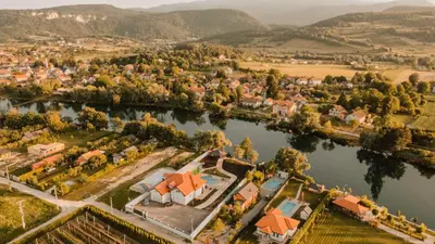 an aerial view of a small village on a river at Grand villa Bosnae in Bihać