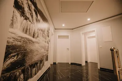 a hallway with a large painting on the wall at Grand villa Bosnae in Bihać