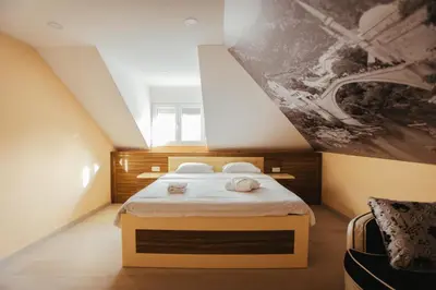 a bedroom with a bed and a painting on the wall at Grand villa Bosnae in Bihać