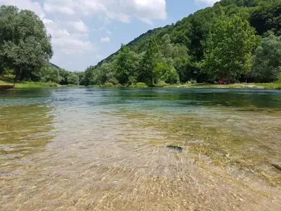 a river with a mountain in the background at Apartman Stari Grad - Ostrožac na Uni - Bihać Cazin in Ostrožac