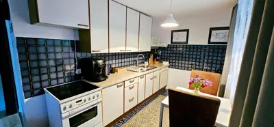 a kitchen with white cabinets and a sink and a stove at Apartman Stari Grad - Ostrožac na Uni - Bihać Cazin in Ostrožac