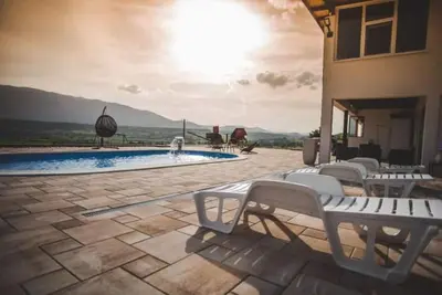a group of chairs sitting next to a swimming pool at Villa Vanesa Bihać in Bihać