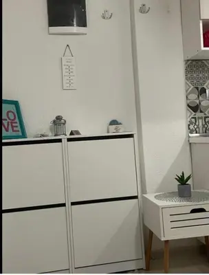 a white cabinet in a kitchen with a desk at Central13 App 2 in Tuzla