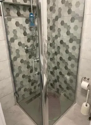 a shower with a glass door in a bathroom at Central13 App 2 in Tuzla