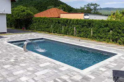 a swimming pool with a water fountain at Villa Asja in Bihać