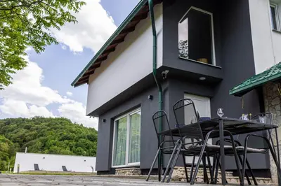 a house with a table and chairs outside of it at Villa Asja in Bihać