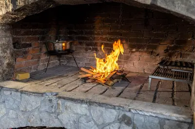 a brick oven with a fire in it at Villa Asja in Bihać