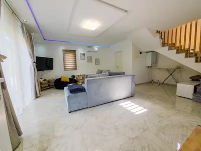 a living room with a couch and a staircase at Villa Asja in Bihać