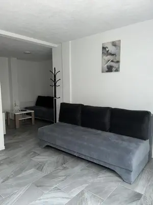 a living room with a couch in the middle of a room at Apartman Jasko 1 in Jajce