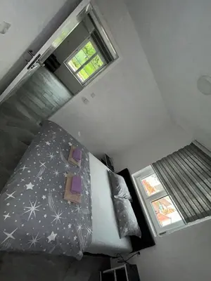 an attic bedroom with a bed and a window at Apartman Jasko 1 in Jajce