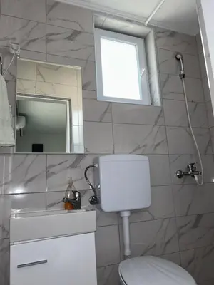 a bathroom with a white toilet and a mirror at Apartman Jasko 1 in Jajce