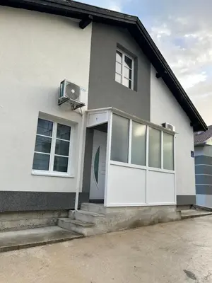 a white house with a white door and windows at Apartman Jasko 1 in Jajce