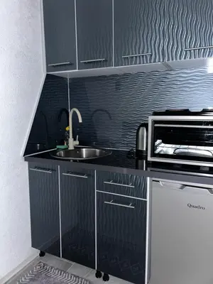 a kitchen with a sink and a microwave at Apartman Jasko 1 in Jajce