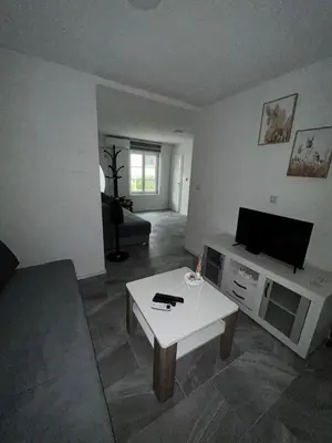 a living room with a tv and a coffee table at Apartman Jasko 1 in Jajce